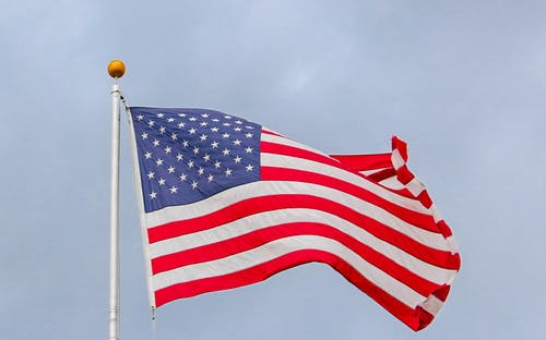 A red, white and blue American Flag is flown on a clear blue day