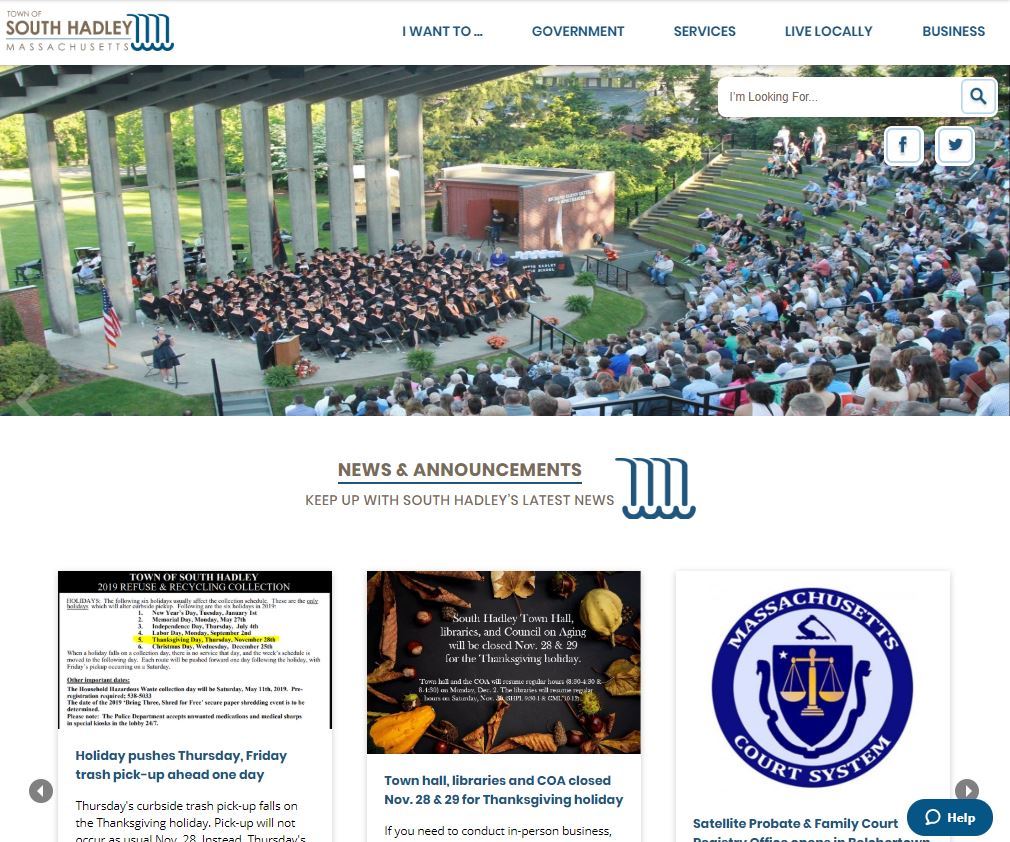 A photo of a graduating class sits in an amphitheater above a town website calendar and news section