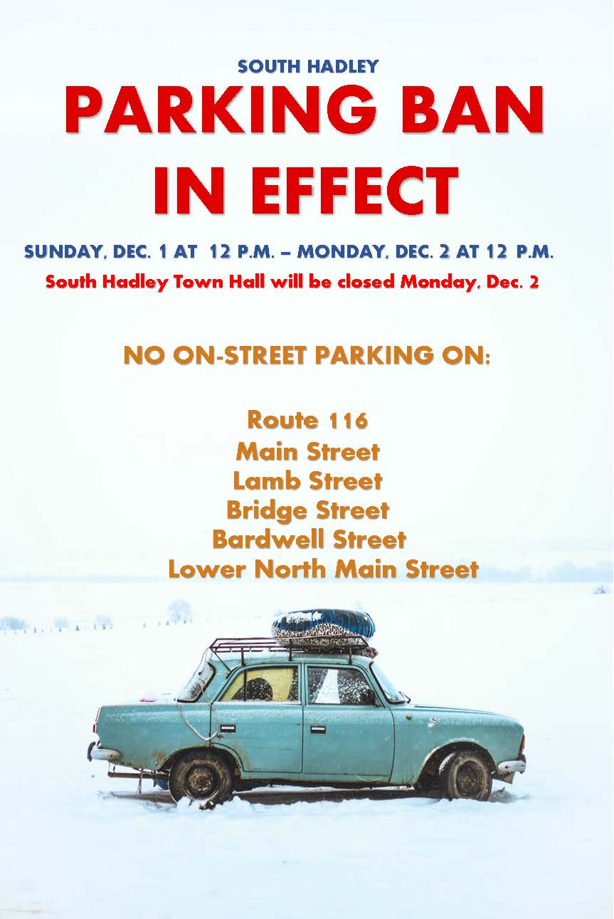 A vintage, blue car is parked on a white, snow covered area