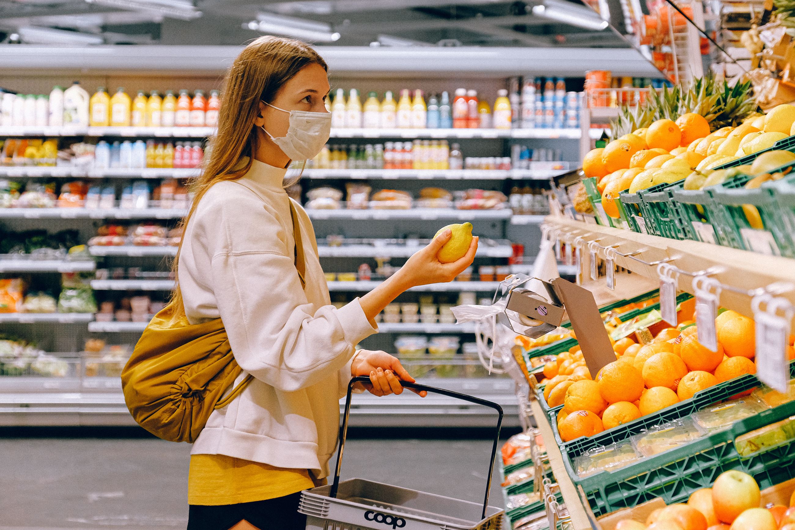 A woman wears a mask inside of a grocery store 